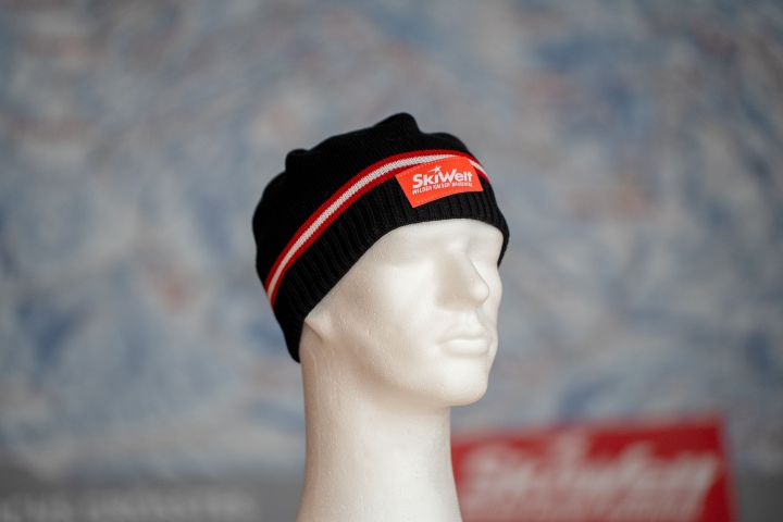 a black hat with red stripe SkiWelt
